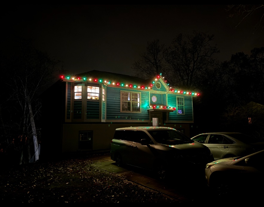 Red green and white Christmas roofline lights on a split-level home